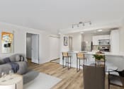 Thumbnail 32 of 73 - a living room with a kitchen and dining area at Lakemont Orchard, Issaquah, WA  
