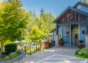 Thumbnail 73 of 73 - a patio in front of a blue building with a porch at Lakemont Orchard, Issaquah, 98027  