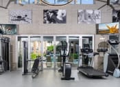 Thumbnail 54 of 84 - Gym with cardio equipment and pictures on the wall at Level at Sixteenth, Phoenix, AZ, 85014