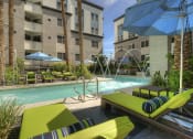 Thumbnail 8 of 84 - Resort-style pool with fountains and chaise lounge seating at Level at Sixteenth, Phoenix, 85014
