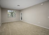 Thumbnail 9 of 25 - Living Room with Carpet Flooring and a Large Window at 55+ Remington at Ladera Ranch, Ladera Ranch
