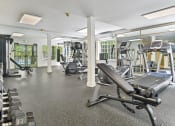 Thumbnail 9 of 73 - a gym with cardio equipment and weights at Lakemont Orchard, Issaquah  