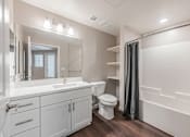 Thumbnail 75 of 90 - A white bathroom with a sink, toilet, and bathtub.
