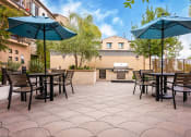 Thumbnail 9 of 72 - an outdoor patio with tables and umbrellas