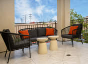Thumbnail 20 of 72 - a patio with a couch and two chairs