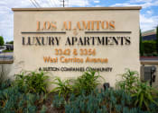 Thumbnail 23 of 72 - a sign for los alamitos luxury apartments