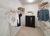 Thumbnail 39 of 39 - a walk in closet with clothes hanging on racks and a dresser at McDermott Place, Plano, Texas
