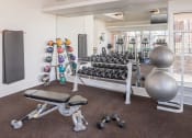 Thumbnail 35 of 39 - A gym with a bench, dumbbells, and a ball at McDermott Place, Texas 75025