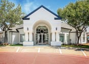 Thumbnail 3 of 39 - a white building with an arched doorway and a large window at McDermott Place, Texas