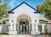 Thumbnail 1 of 39 - Exterior of Leasing Office with Window Door, White Walls, Trees, and Manicured Lawn at McDermott Place, Plano, Texas