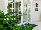 Thumbnail 24 of 39 - a large glass door with a round window and a blue rug in front of it at McDermott Place, Plano, TX