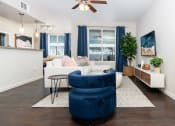 Thumbnail 61 of 78 - a living room with a white couch and a blue chair at Miro at the Parc, Nevada 89074
