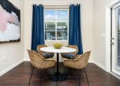 Thumbnail 65 of 78 - a dining area with a table and chairs and a window at Miro at the Parc, Henderson, Nevada