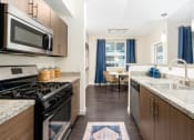 Thumbnail 59 of 78 - a kitchen with stainless steel appliances and granite counter tops at Miro at the Parc, Henderson