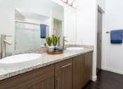 Thumbnail 77 of 78 - a bathroom with two sinks and a large mirror at Miro at the Parc, Henderson, NV