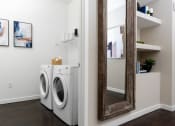 Thumbnail 78 of 78 - a small laundry room with a washing machine and a mirror at Miro at the Parc, Henderson, 89074