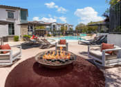 Thumbnail 21 of 78 - a patio with a fire pit and chairs and a pool at Miro at the Parc, Nevada