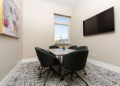 Thumbnail 10 of 78 - a conference room with a table and chairs and a television at Miro at the Parc, Henderson, Nevada