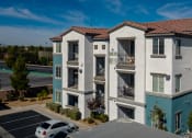 Thumbnail 32 of 78 - an aerial view of an apartment building with a parking lot at Miro at the Parc, Henderson, NV