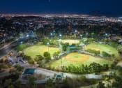Thumbnail 35 of 78 - an aerial view of baseball fields at night at Miro at the Parc, Henderson, NV