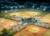 Thumbnail 34 of 78 - an aerial view of a baseball field at night at Miro at the Parc, Henderson, NV 89074