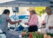 Thumbnail 39 of 78 - people buying food at a farmers market at Miro at the Parc, Henderson
