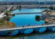 Thumbnail 44 of 78 - people walking across a bridge over a river at Miro at the Parc, Nevada 89074