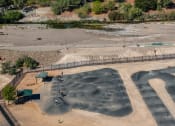 Thumbnail 47 of 78 - an aerial view of a bike park with ramps and a river at Miro at the Parc, Henderson, Nevada