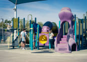 Thumbnail 54 of 78 - people playing at a playground at a park at Miro at the Parc, Henderson, NV