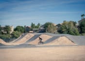 Thumbnail 57 of 78 - person riding a bike at the bike park at Miro at the Parc, Henderson