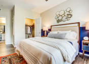 Thumbnail 21 of 36 - Spacious Bedroom With Wood-Style Plank Flooring, Area Rug, Bed, Nightstands With Lamps, Walk-In Closet, And En-Suite Bathroom at Montrachet Apartments, California, 94558