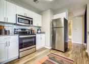 Thumbnail 28 of 36 - Kitchen with stainless steel appliances at Montrachet Apartments, Napa, CA, 94558