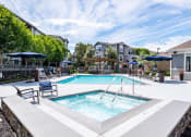 Thumbnail 35 of 36 - Outdoor pool and jacuzzi area with lounge chairs at Montrachet Apartments, California