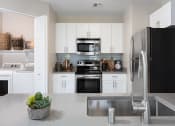 Thumbnail 20 of 36 - kitchen with white cabinets and stainless steel appliances at Montrachet Apartments, California, 94558