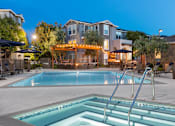 Thumbnail 16 of 34 - A pool with a slide and a building behind it.