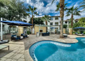Thumbnail 40 of 67 - Chandler, AZ, Apartments for Rent - Monument - Pool with Palm Trees, Lounge Chairs, and Outdoor Sofas.