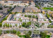 Thumbnail 18 of 67 - an aerial view of a city with houses and cars