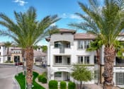 Thumbnail 22 of 67 - an apartment building with palm trees in front of it