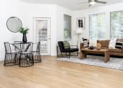 Thumbnail 1 of 67 - Living room and dining area with ceiling fan and balcony door at Monument, Chandler