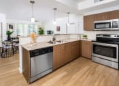 Thumbnail 6 of 67 - Kitchen with Wood-Cabinets, Wood-Style Flooring, and Stainless-Steel Appliances at Monument, Arizona