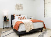 Thumbnail 15 of 67 - Apartments for Rent Chandler, AZ - Monument - Bedroom with Plush Carpeting, Window, and Full-Size Bed.