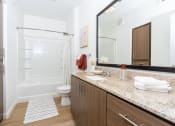 Thumbnail 23 of 67 - a bathroom with a shower toilet and sink and a mirror