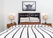 Thumbnail 49 of 67 - a bedroom with a bed and a picture of a bull on the wall