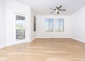 Thumbnail 37 of 67 - an empty living room with a ceiling fan and a window
