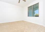 Thumbnail 25 of 67 - an empty room with a window and a ceiling fan