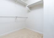 Thumbnail 63 of 67 - a empty room with a white wall and a hanging rail in a closet