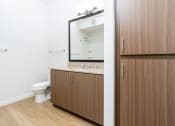 Thumbnail 35 of 67 - a bathroom with a toilet and a sink and a mirror