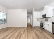 Thumbnail 11 of 44 - A kitchen with white cabinets and a wooden floor. at Nola 624, California