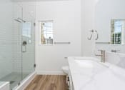 Thumbnail 13 of 44 - A white bathroom with a walk-in shower and a large sink. at Nola 624, West Covina, 91790  