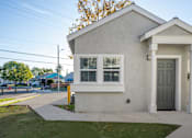 Thumbnail 4 of 44 - A small white house with a grey door and windows. at Nola 624, West Covina  